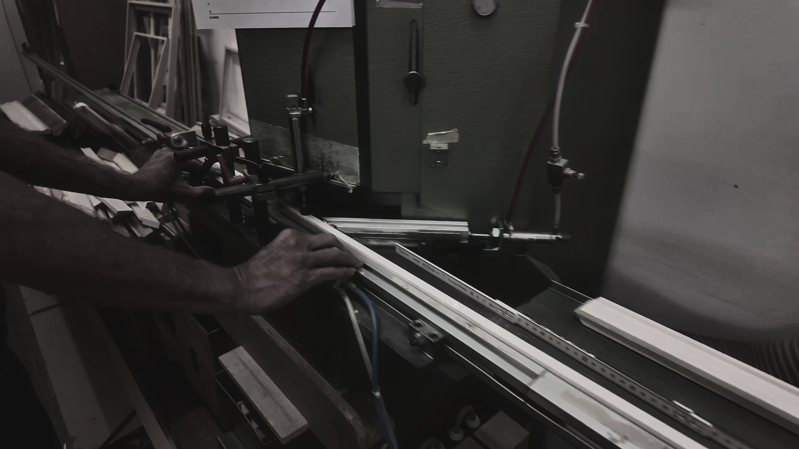 Load video: Handcrafted stainless steel passepartout frame with fine wood surround being produced in a workshop, showing artisan craftsmanship, precise stainless steel cutting and premium picture frame making by hand.